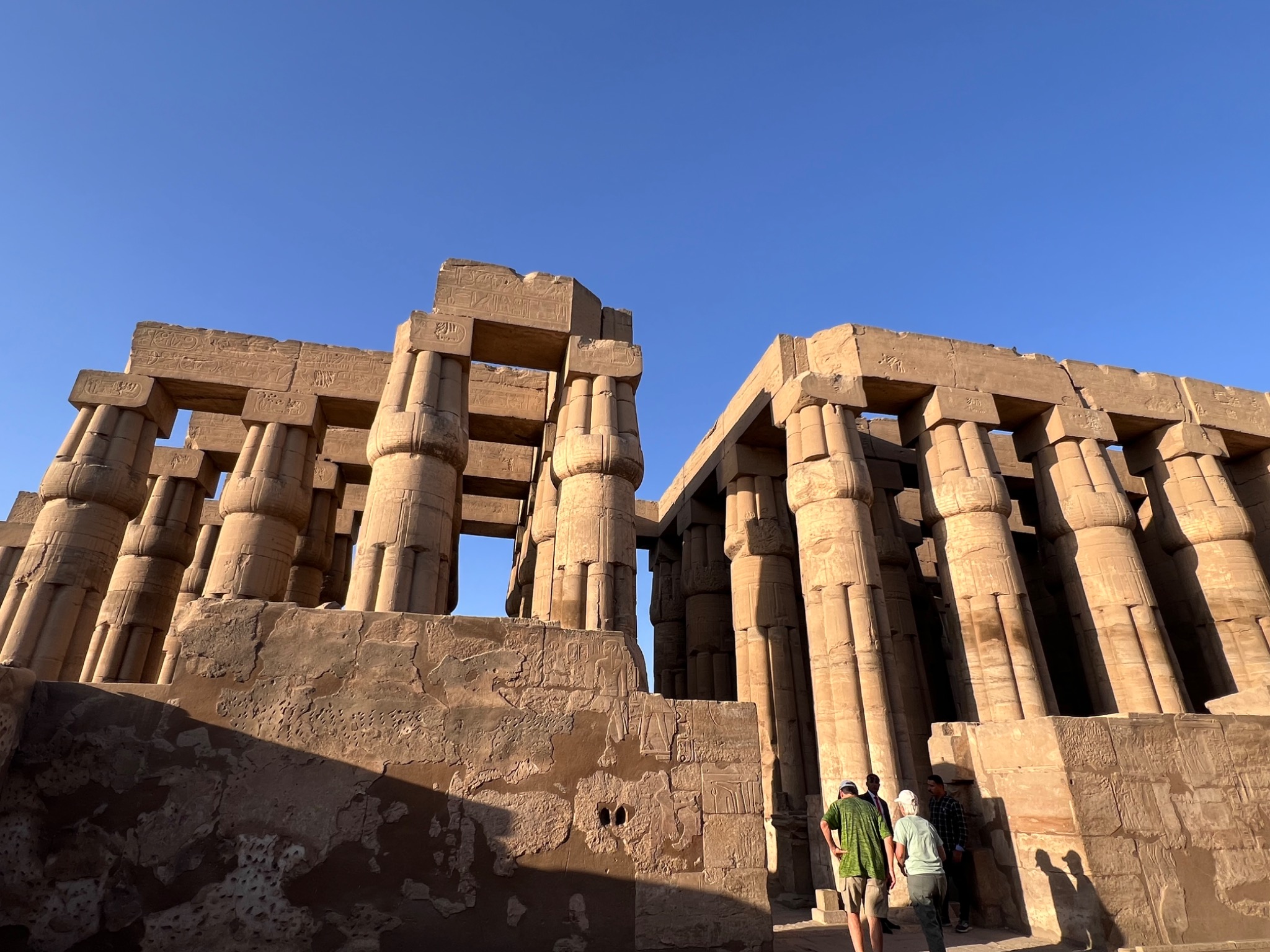 Ancient Egyptian temple columns in golden sunlight beneath a clear blue sky, photographed on Wendy's travels